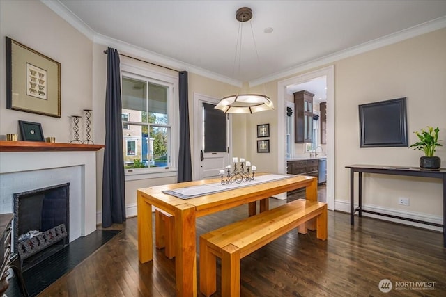 dining area with baseboards, a fireplace with flush hearth, dark wood-style floors, and crown molding