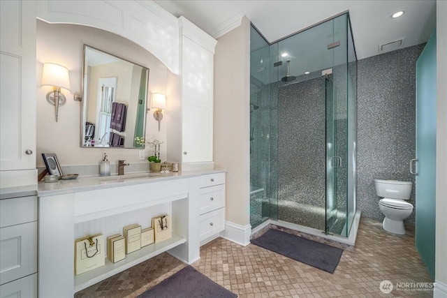 full bath with visible vents, toilet, a stall shower, and vanity