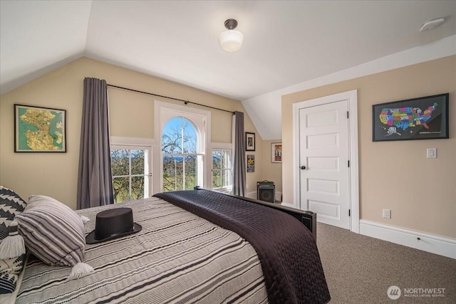 carpeted bedroom with baseboards and lofted ceiling