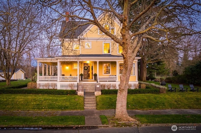 view of front of home with a porch and a front yard