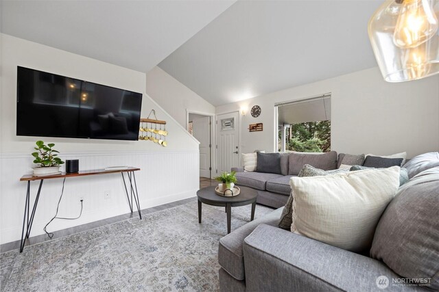 living area featuring lofted ceiling and wood finished floors