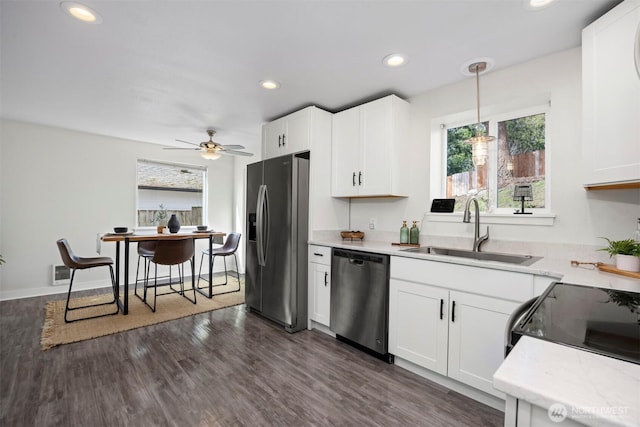 kitchen with a sink, dark wood-style floors, white cabinetry, recessed lighting, and appliances with stainless steel finishes