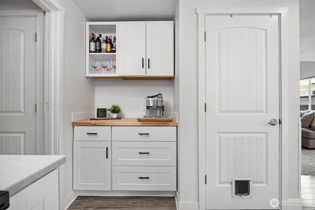 bar with dark wood-style flooring