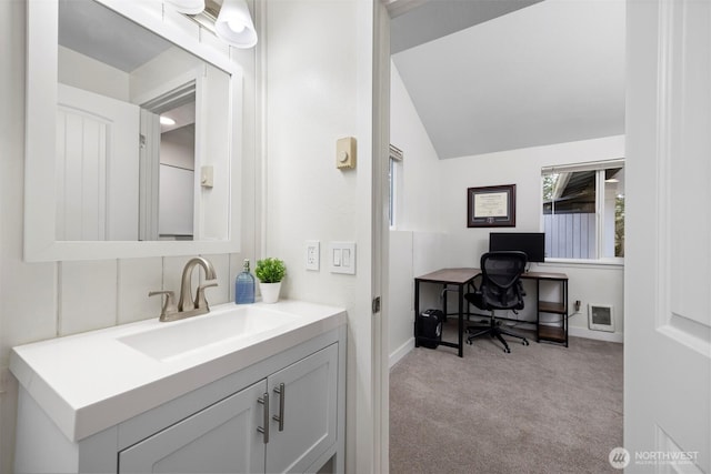 bathroom with vanity and vaulted ceiling