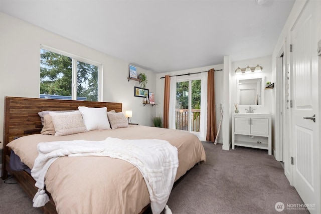 bedroom featuring a sink, carpet, ensuite bath, and access to exterior