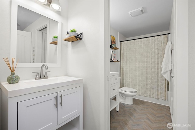 bathroom featuring shower / bathtub combination with curtain, toilet, and vanity