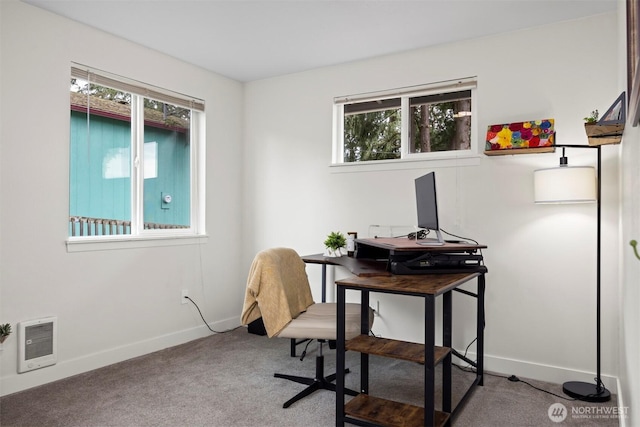 office with heating unit, carpet flooring, baseboards, and plenty of natural light