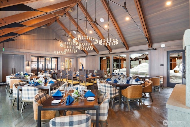 dining room featuring beamed ceiling, high vaulted ceiling, and wood finished floors