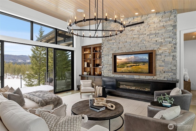 living room with a fireplace, wood ceiling, a high ceiling, and wood finished floors