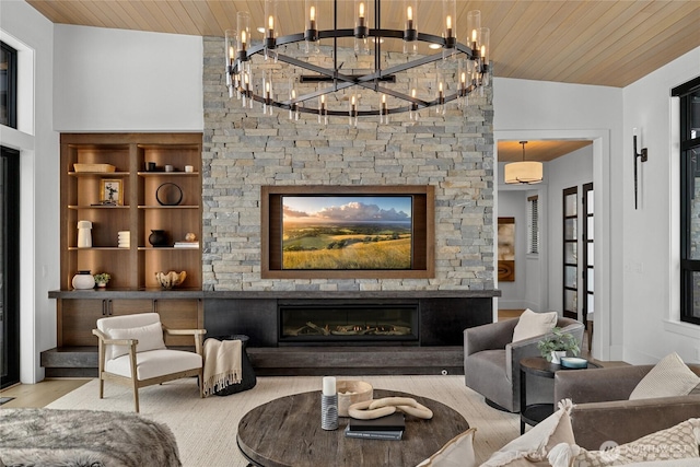 living room with a stone fireplace, wooden ceiling, and wood finished floors