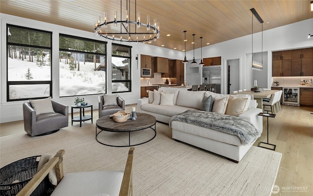 living room with an inviting chandelier, recessed lighting, wine cooler, wooden ceiling, and light wood-type flooring