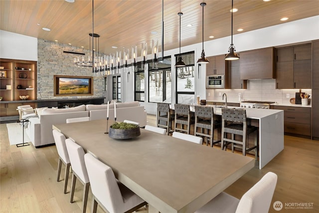 dining area featuring recessed lighting, light wood-style floors, and wood ceiling