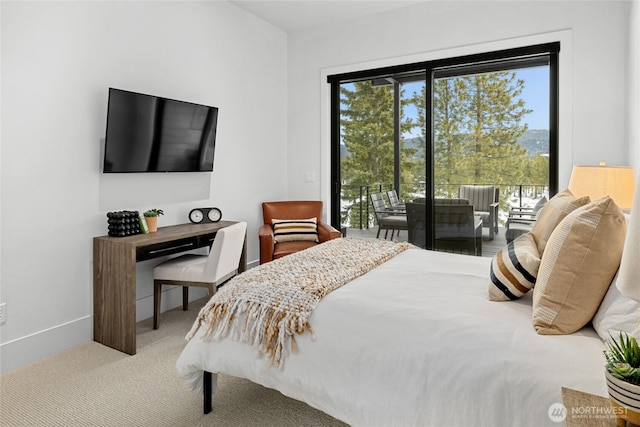 carpeted bedroom with baseboards, multiple windows, and access to exterior