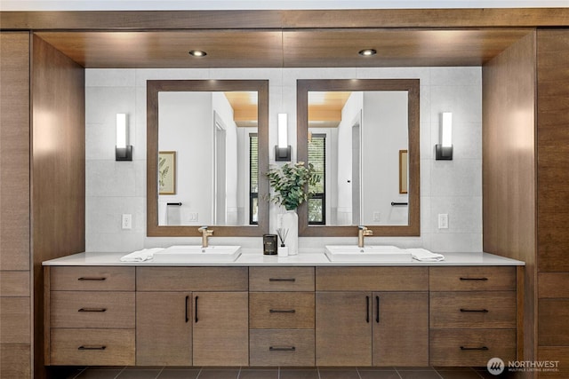 full bathroom featuring double vanity, tile patterned floors, and a sink