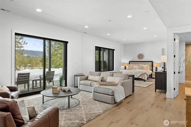 bedroom featuring access to exterior, visible vents, baseboards, light wood-type flooring, and recessed lighting