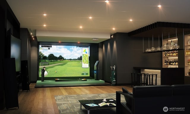 rec room featuring a dry bar, wood finished floors, and golf simulator