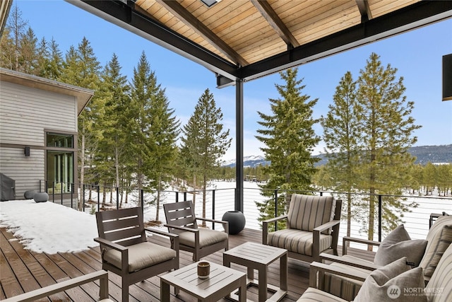 snow covered deck featuring an outdoor living space