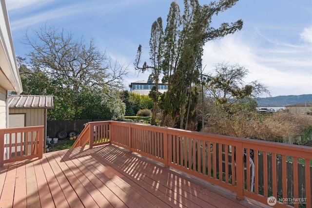 deck with an outbuilding and fence