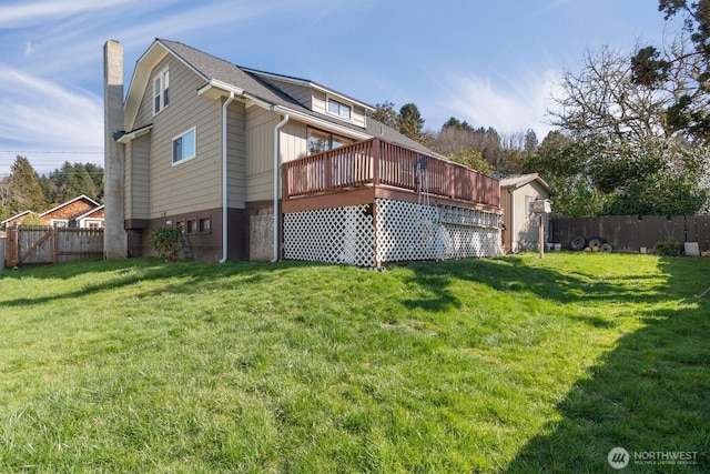 view of home's exterior with a fenced backyard, a lawn, a chimney, and a wooden deck