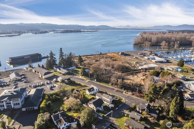 aerial view featuring a water and mountain view