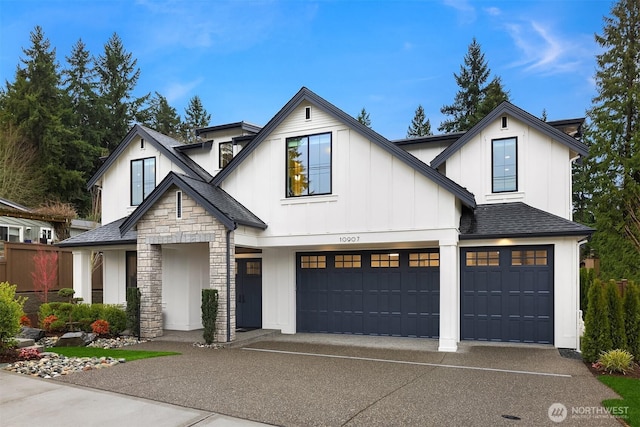 modern inspired farmhouse featuring board and batten siding, a shingled roof, concrete driveway, stone siding, and an attached garage