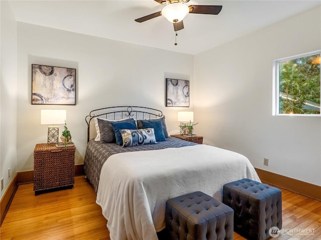 bedroom with baseboards, ceiling fan, and light wood finished floors