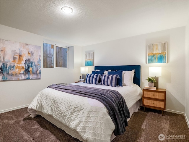 carpeted bedroom with baseboards and a textured ceiling