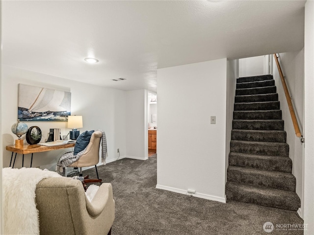 interior space with visible vents, baseboards, and dark colored carpet