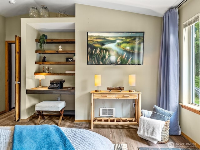 bedroom with wood finished floors and baseboards