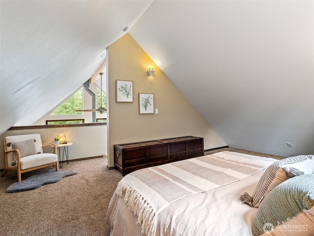 carpeted bedroom featuring baseboards and lofted ceiling