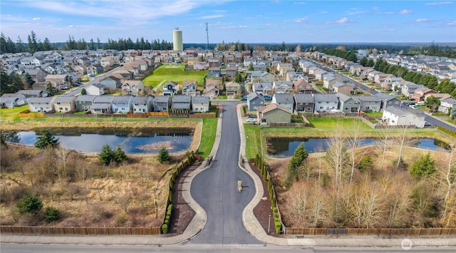 drone / aerial view featuring a residential view and a water view