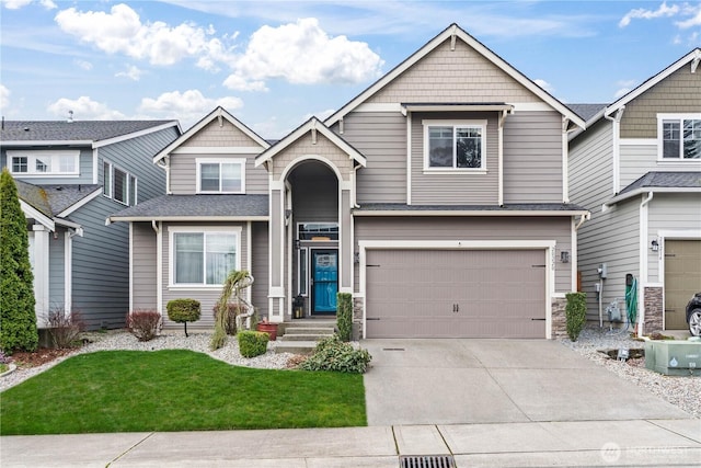 view of front of property with driveway, an attached garage, and roof with shingles