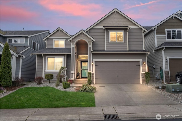 view of front facade with driveway, an attached garage, and a front lawn