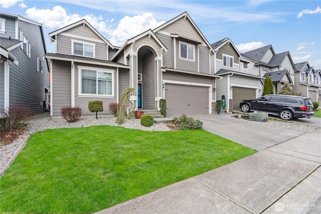 view of front of property featuring a garage, a front lawn, and driveway