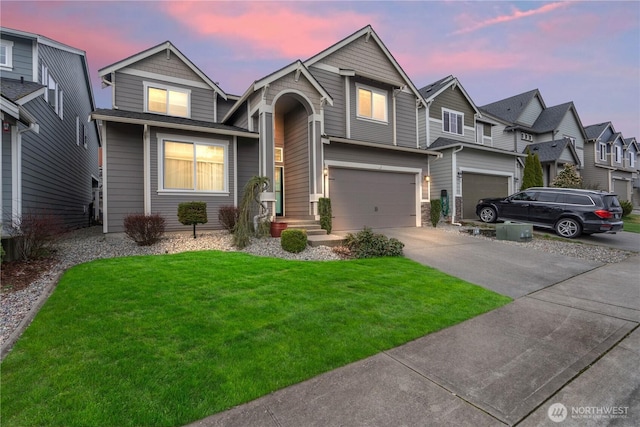 view of front of house with driveway, a front yard, and a garage