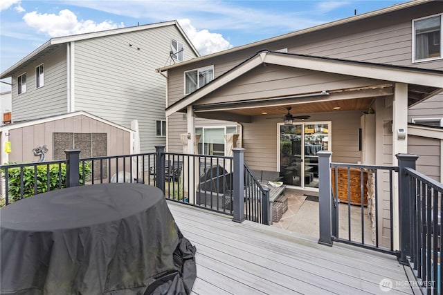 wooden deck featuring area for grilling and ceiling fan