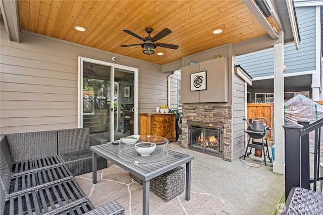 view of patio with an outdoor stone fireplace and ceiling fan