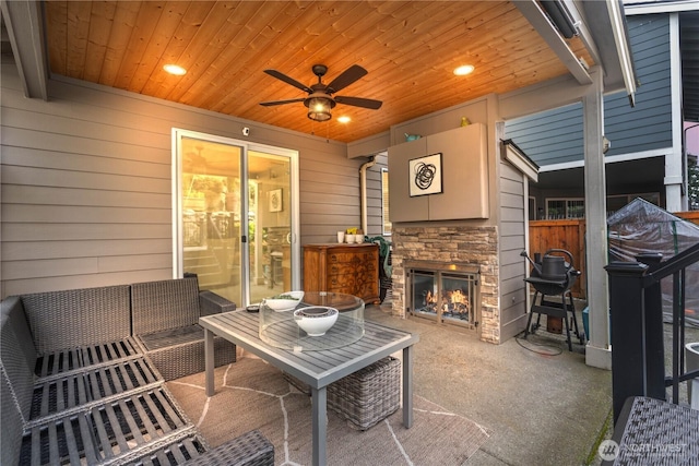 view of patio with an outdoor stone fireplace and a ceiling fan