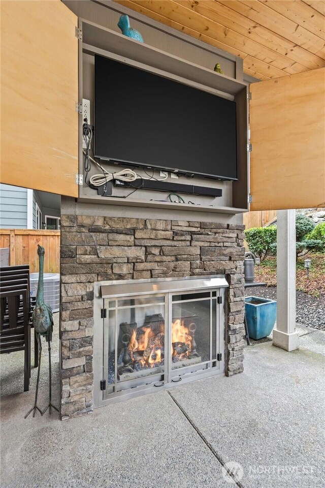 interior details with central AC unit and an outdoor stone fireplace