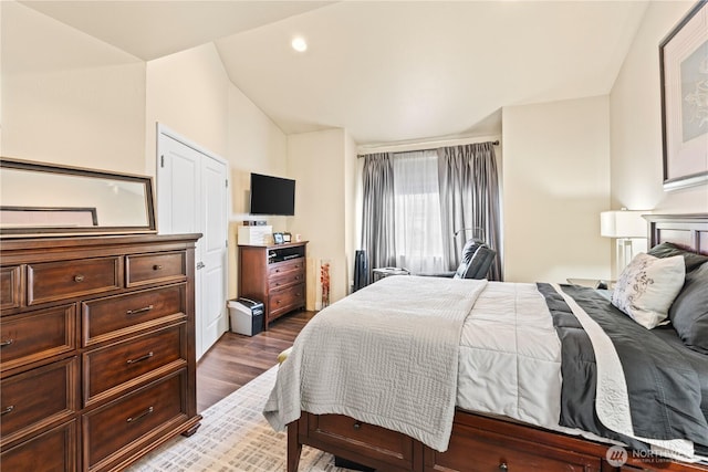 bedroom with recessed lighting, dark wood finished floors, and vaulted ceiling