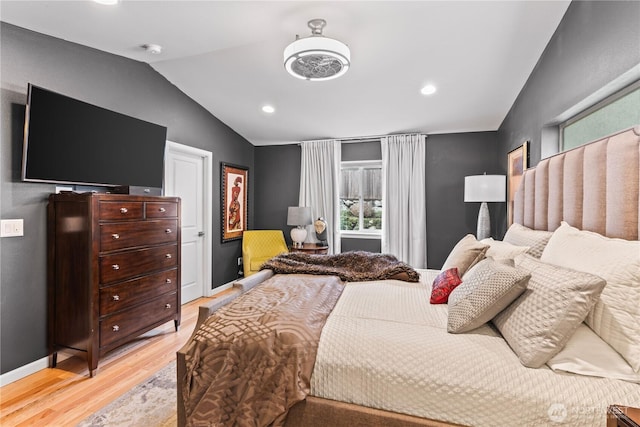 bedroom with lofted ceiling, light wood-style flooring, recessed lighting, and baseboards