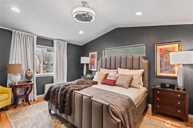 bedroom with recessed lighting, baseboards, lofted ceiling, and wood finished floors