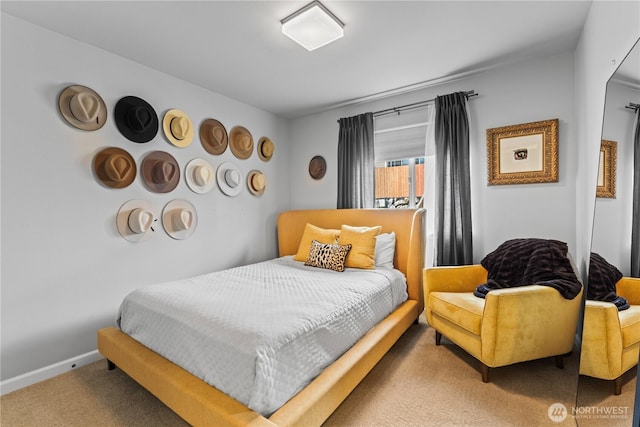 bedroom with baseboards and carpet floors