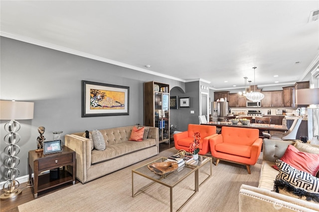 living room with visible vents, a chandelier, ornamental molding, recessed lighting, and wood finished floors