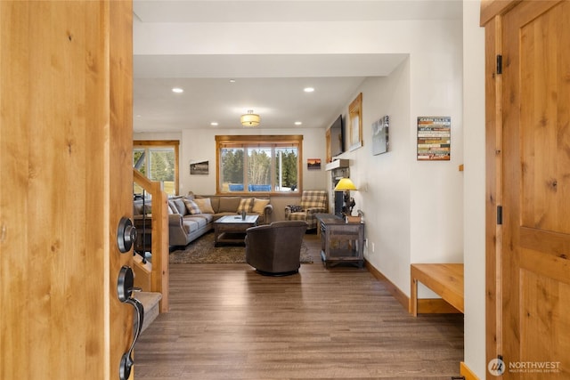 living area with baseboards, wood finished floors, stairs, and recessed lighting