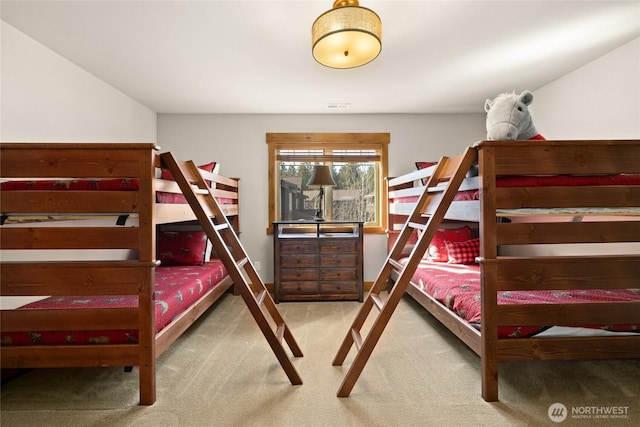 carpeted bedroom featuring visible vents