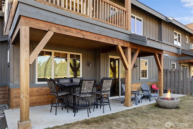 view of patio / terrace featuring fence and a fire pit