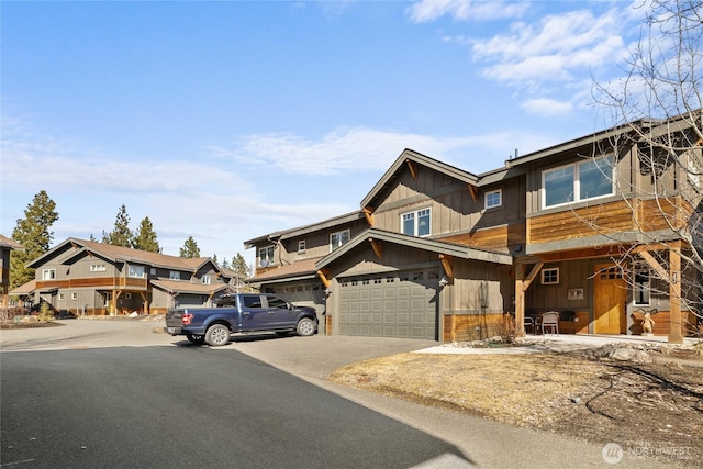 view of front of house with a garage, driveway, and a residential view