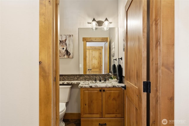 bathroom featuring vanity and toilet