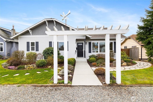 view of front of home featuring a front yard and fence